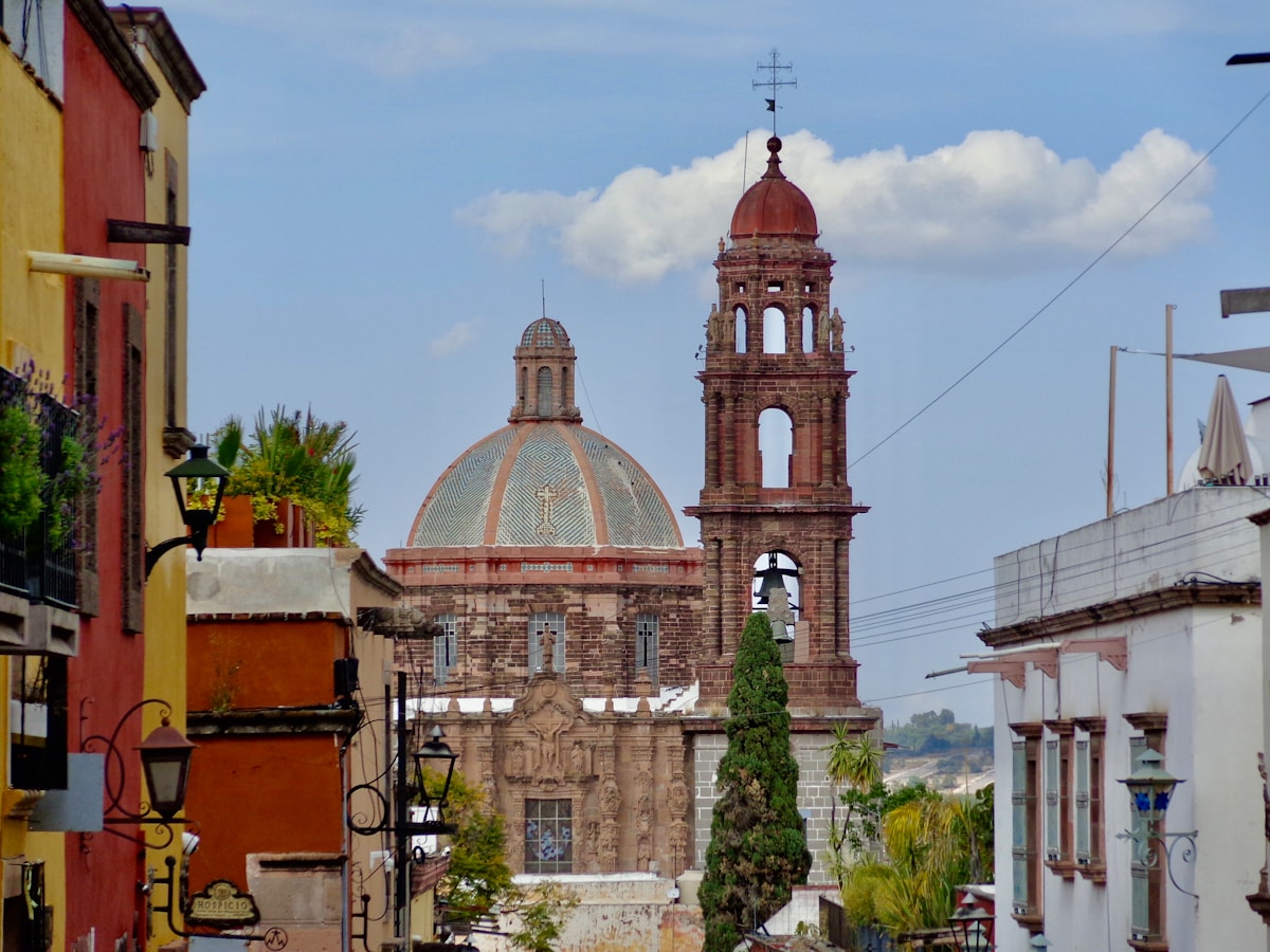 Colorful colonial street leading to a domed church in San Miguel de Allende, a Pueblo Mágico in central Mexico