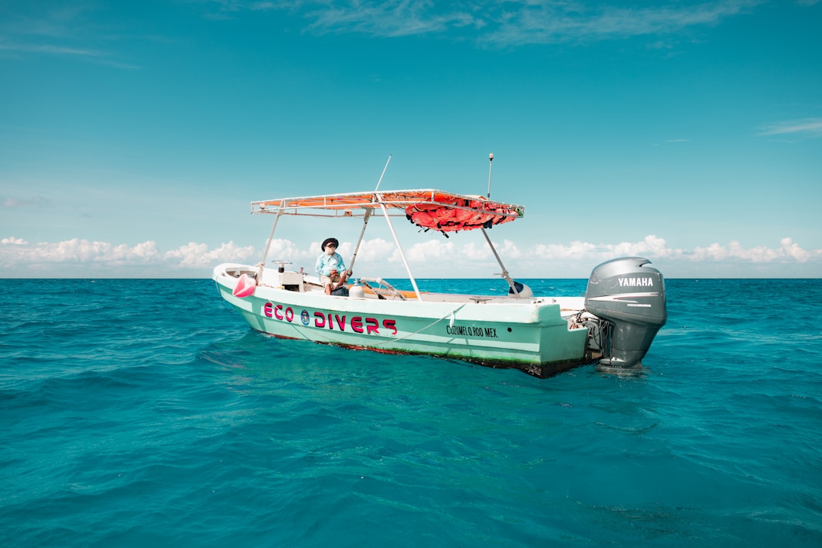 Small boat floating in turquoise Caribbean waters off Cozumel, Quintana Roo, Mexico