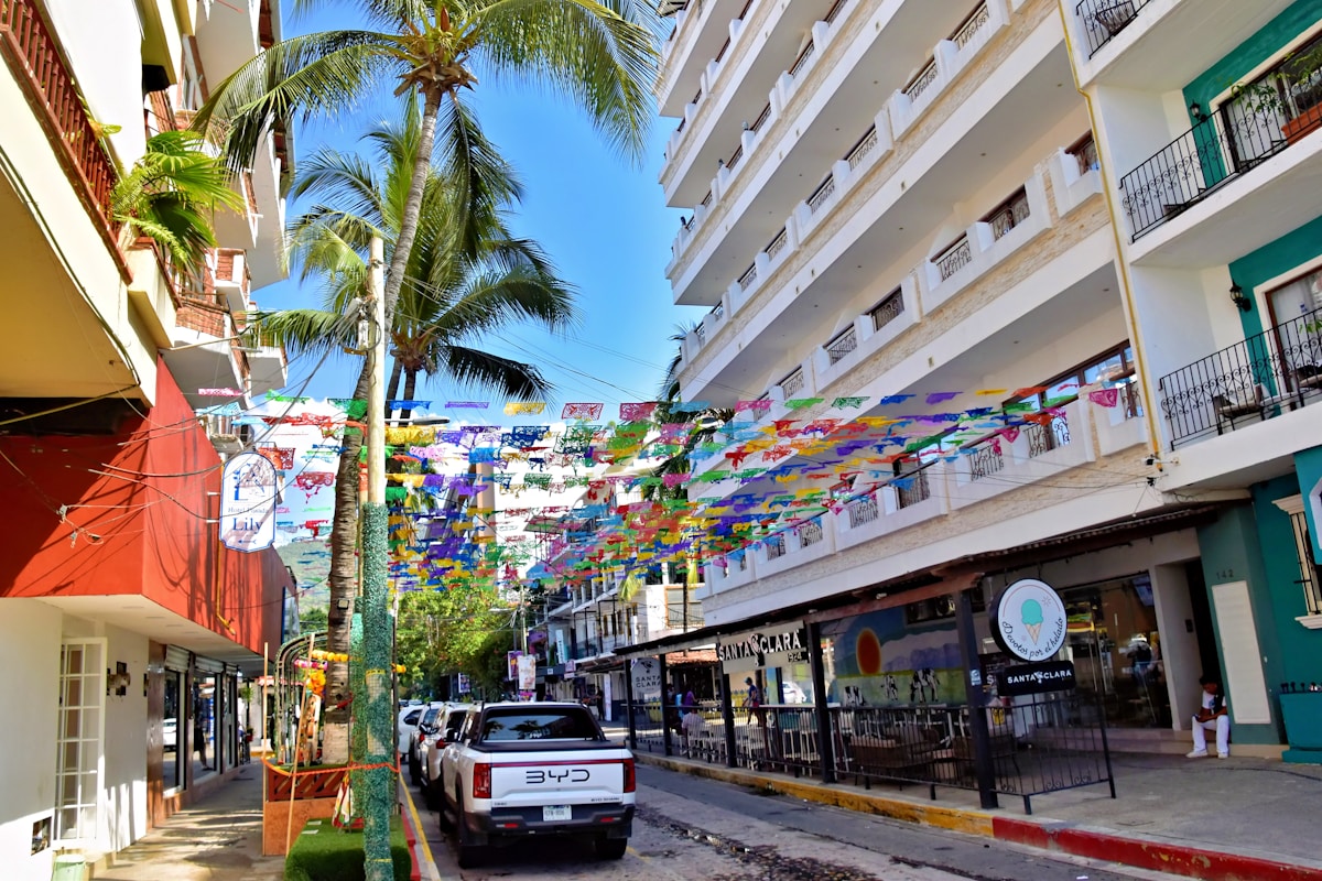 Colorful flags strung between buildings on a Puerto Vallarta street in Zona Romantica