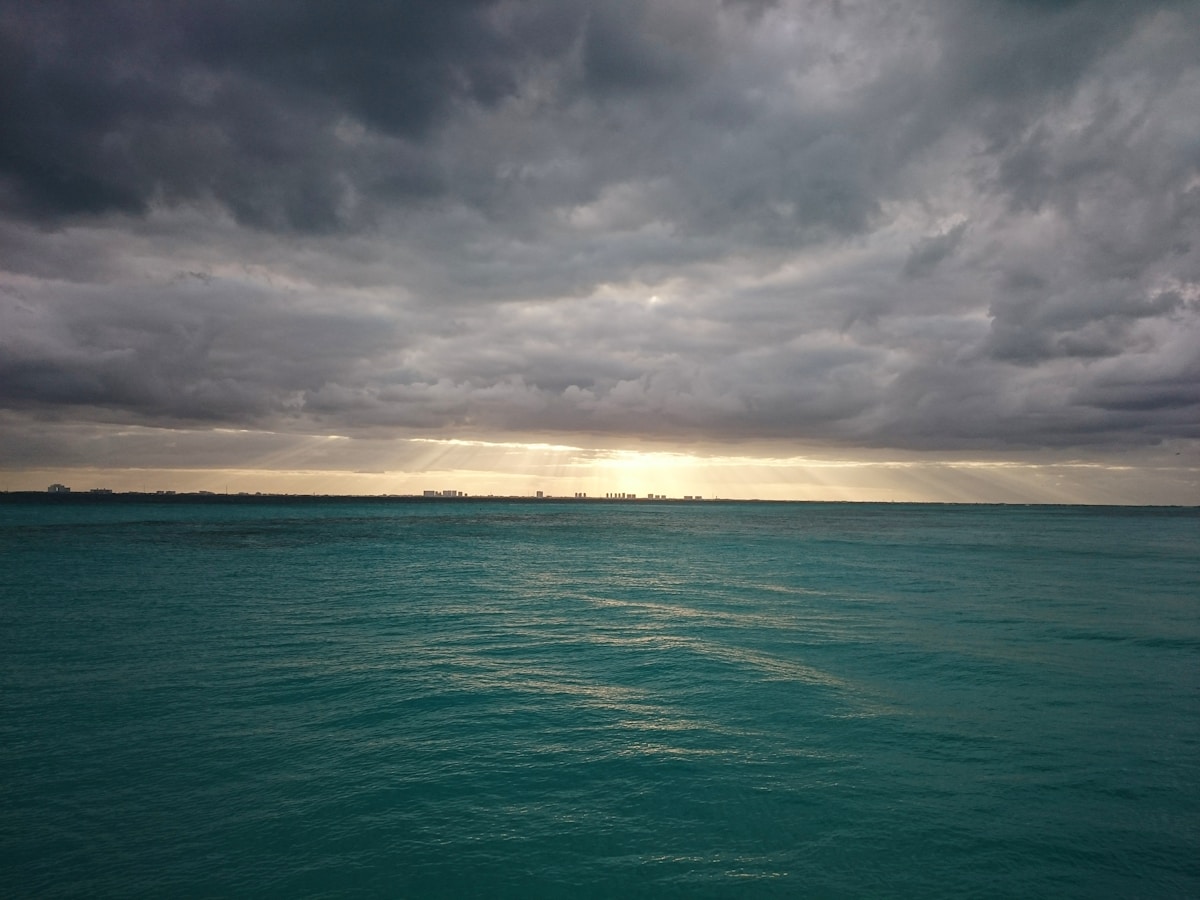 Turquoise Caribbean sea from Isla Mujeres with Cancún skyline visible on the horizon