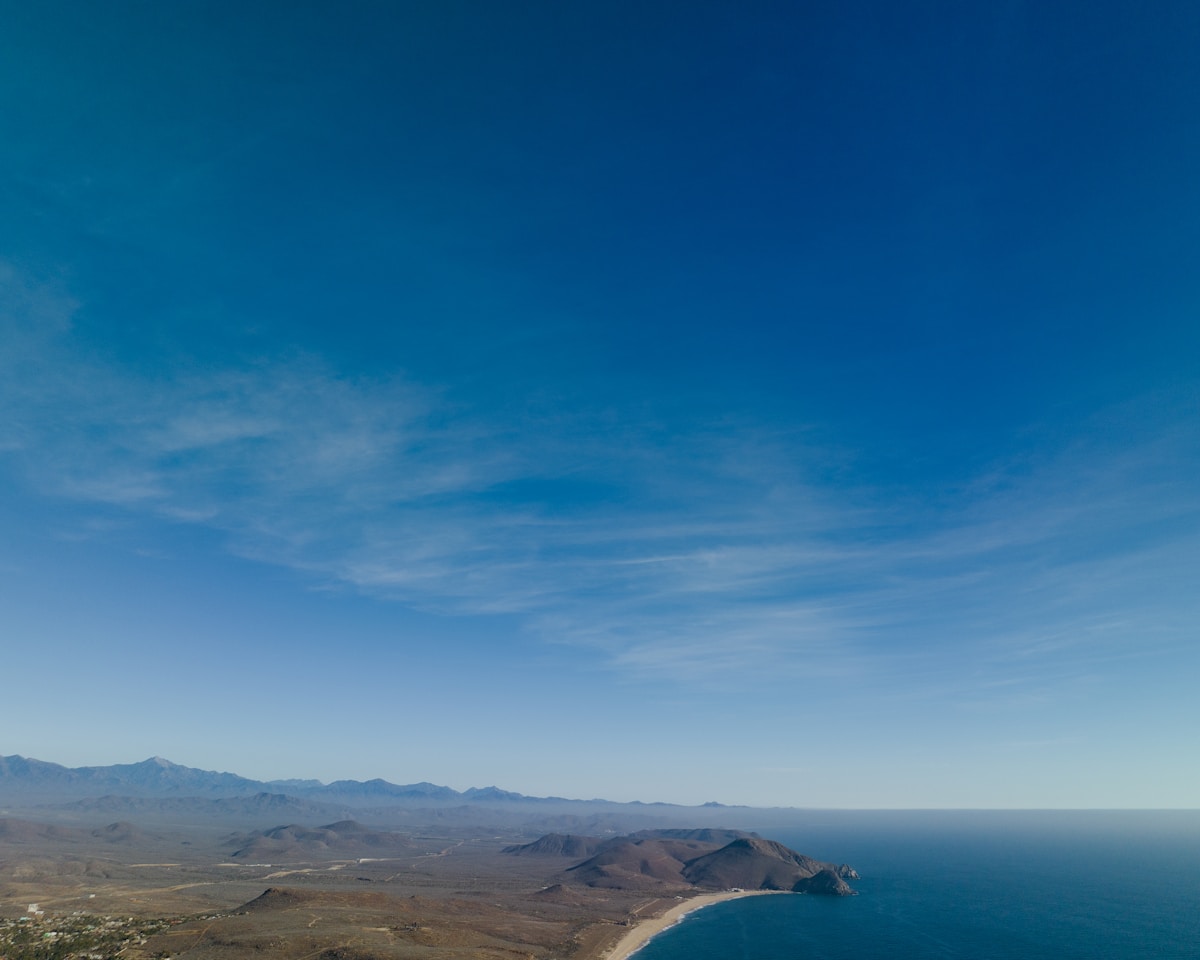 Aerial view of Baja California coastline with mountains, sea, and small town, Todos Santos, Mexico