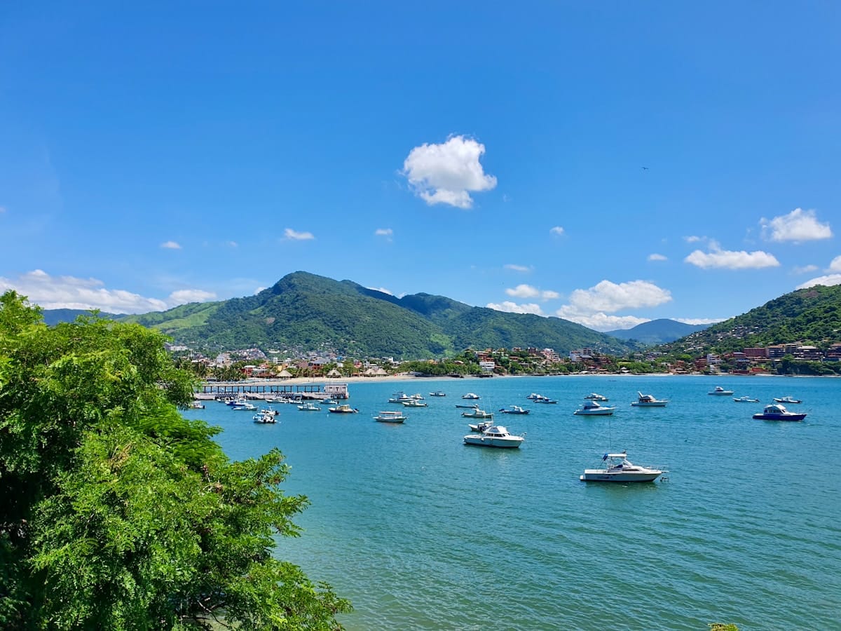Zihuatanejo bay with boats and green mountains in the background