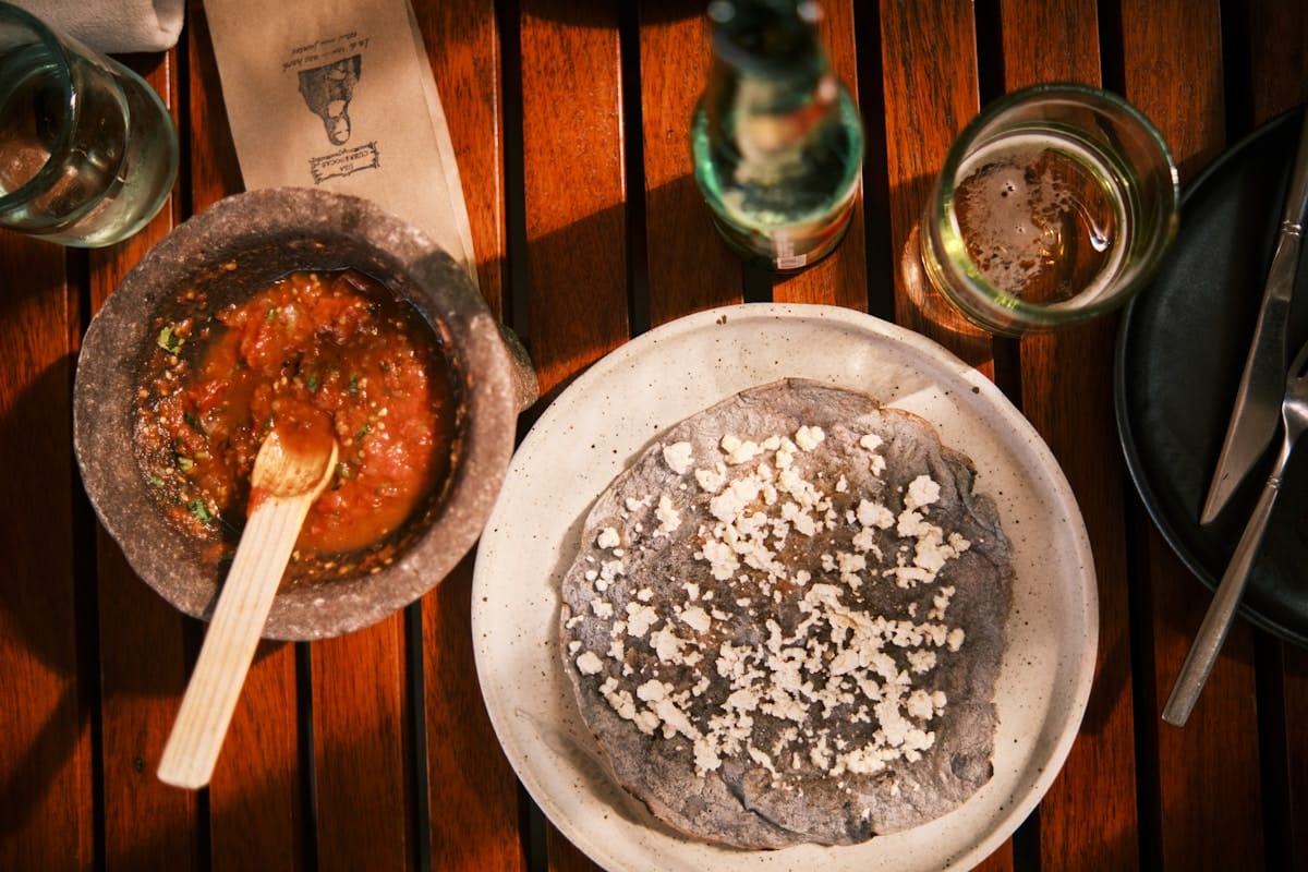 Colourful Oaxacan food spread including mole negro, tlayudas, and fresh tortillas