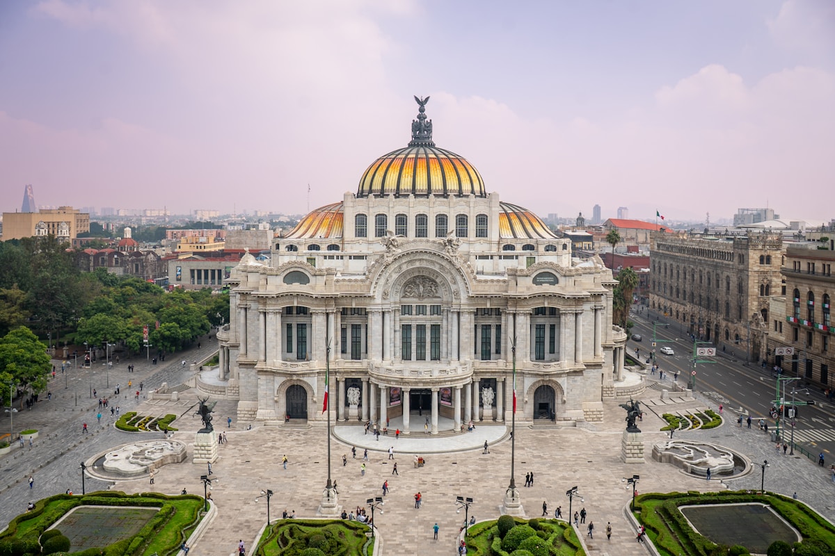 Palacio de Bellas Artes golden dome with the Mexico City skyline behind