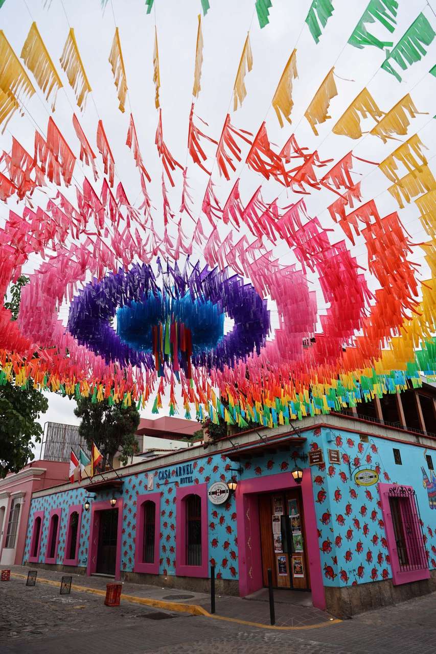 Colourful papel picado banners strung over a street in Oaxaca, Mexico