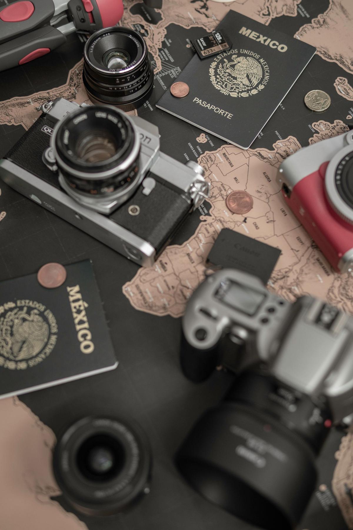 Mexican passports with cameras on a world map