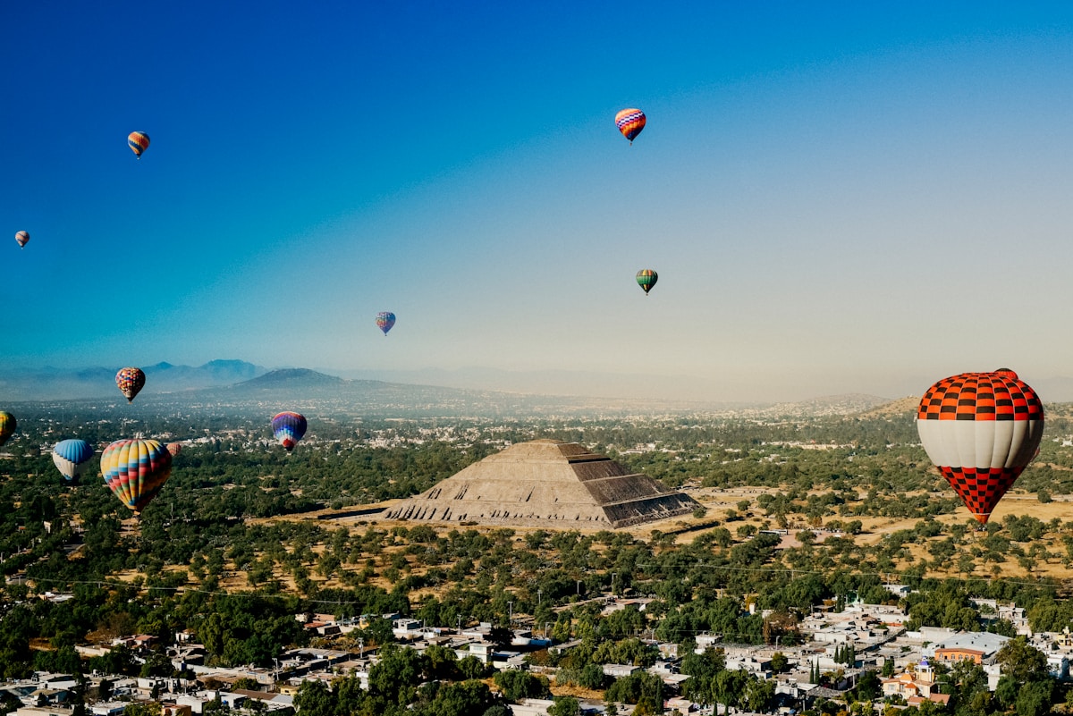 Teotihuacán pyramids with hot air balloons above the Avenue of the Dead