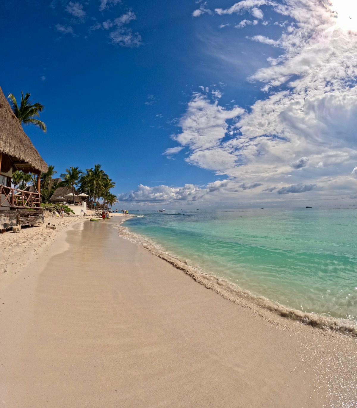 Sandy beach with thatched roof palapa, Playa del Carmen, Mexico