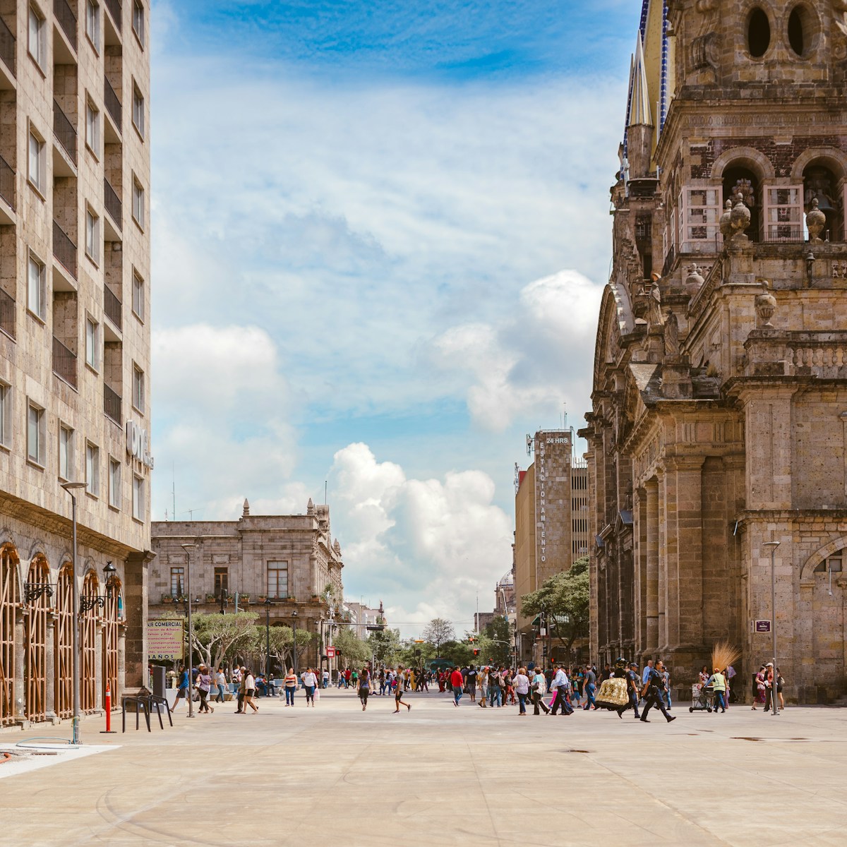 People walking near ancient cathedral, Guadalajara, Mexico