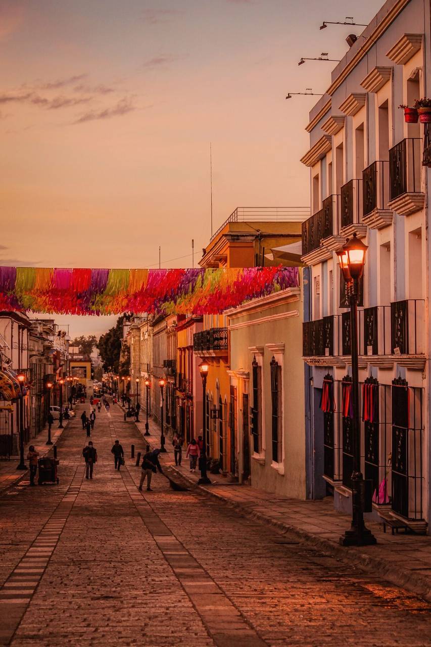 Colourful street with festive bunting at sunset, Oaxaca City, Mexico