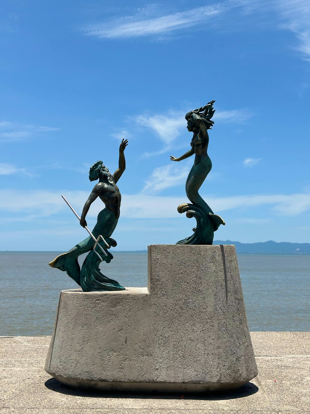 Los Arcos mermaid statue on rocky shore, Puerto Vallarta, Jalisco, Mexico