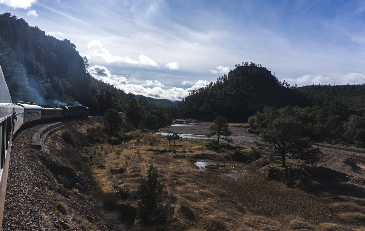 Train travelling through mountain valley on the Chihuahua al Pacífico railway, Sierra Tarahumara, Mexico