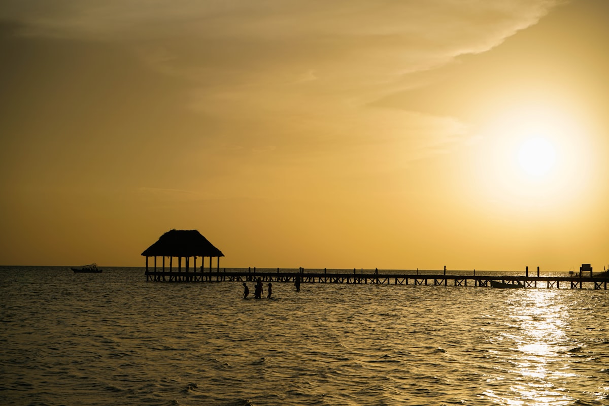Palapa pier at sunset over calm turquoise water, Isla Holbox, Quintana Roo, Mexico