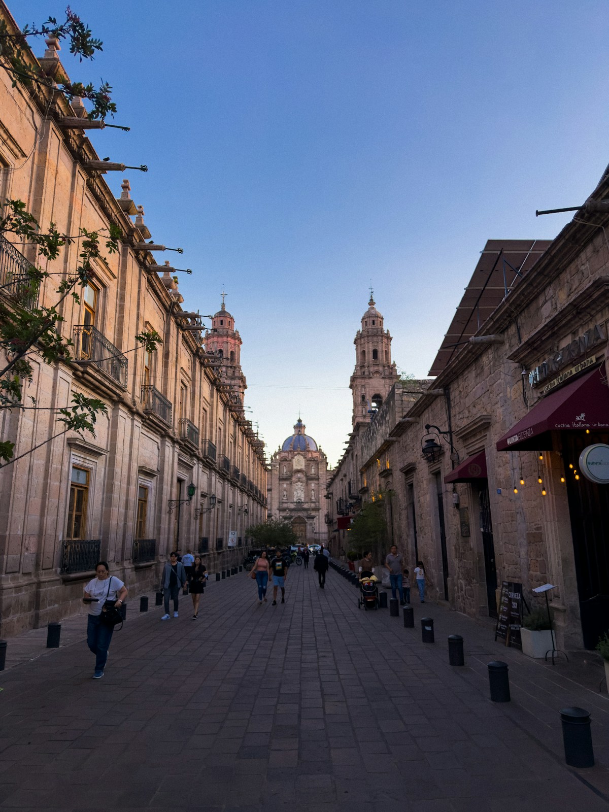 Pedestrian street lined with colonial stone buildings leading to Morelia cathedral, Michoacán, Mexico