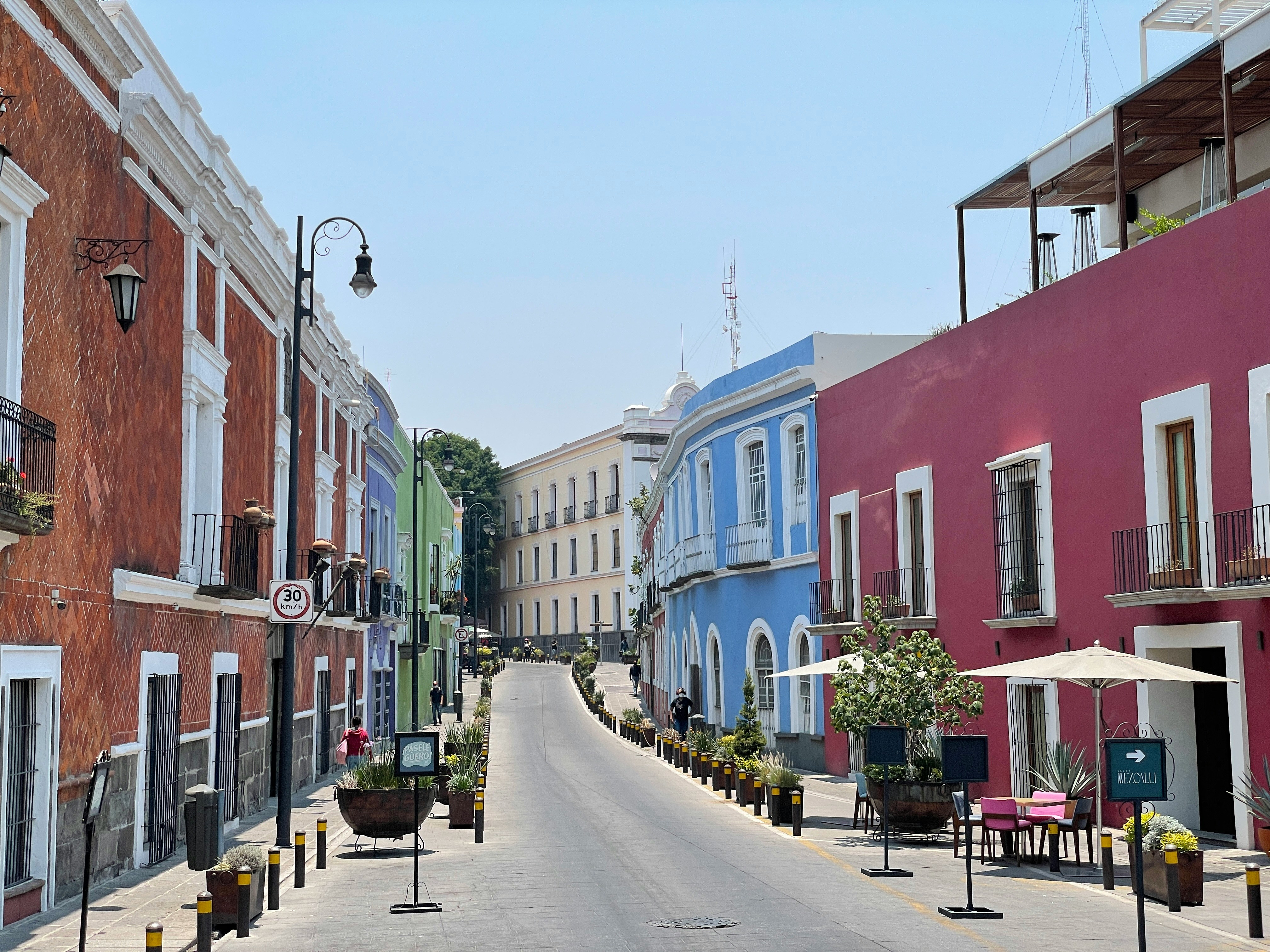 Colourful colonial street with restaurant terraces in Puebla, Mexico